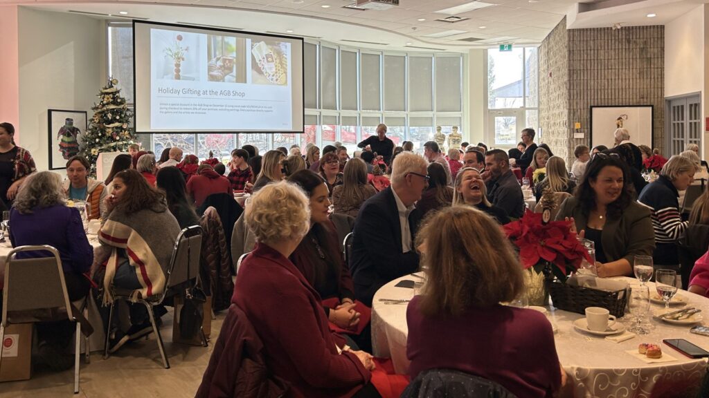 People sitting at round tables enjoying eachothers company at Soup Bowl event at the Art Gallery of Burlington.